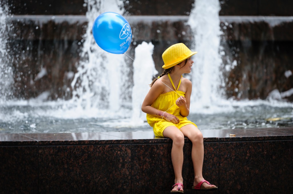 Street photography - Girl in yellow with a blue balloon
