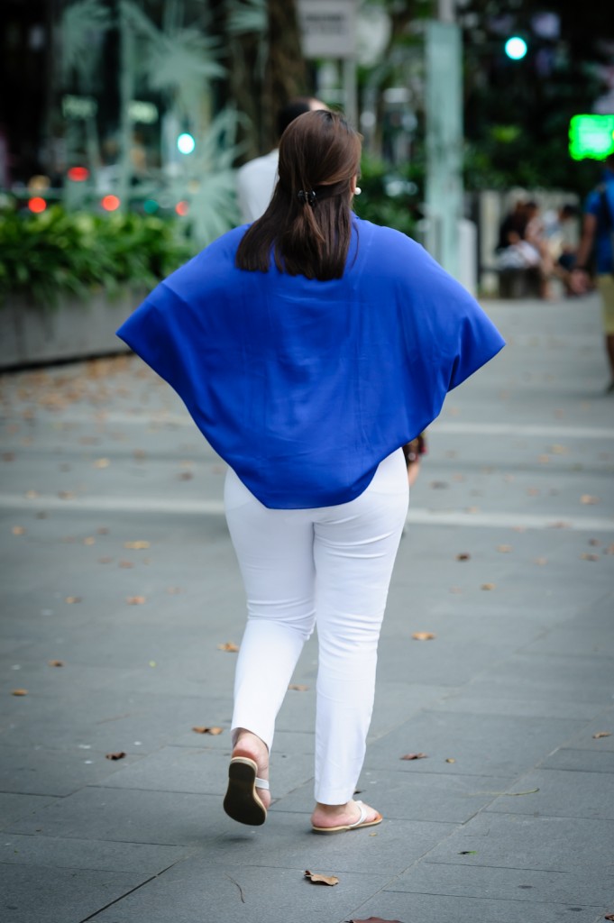 Street photography - Woman in blue top and white pants