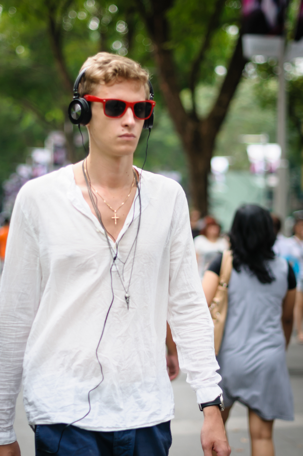 Street photography - tall man wearing shades and headphones