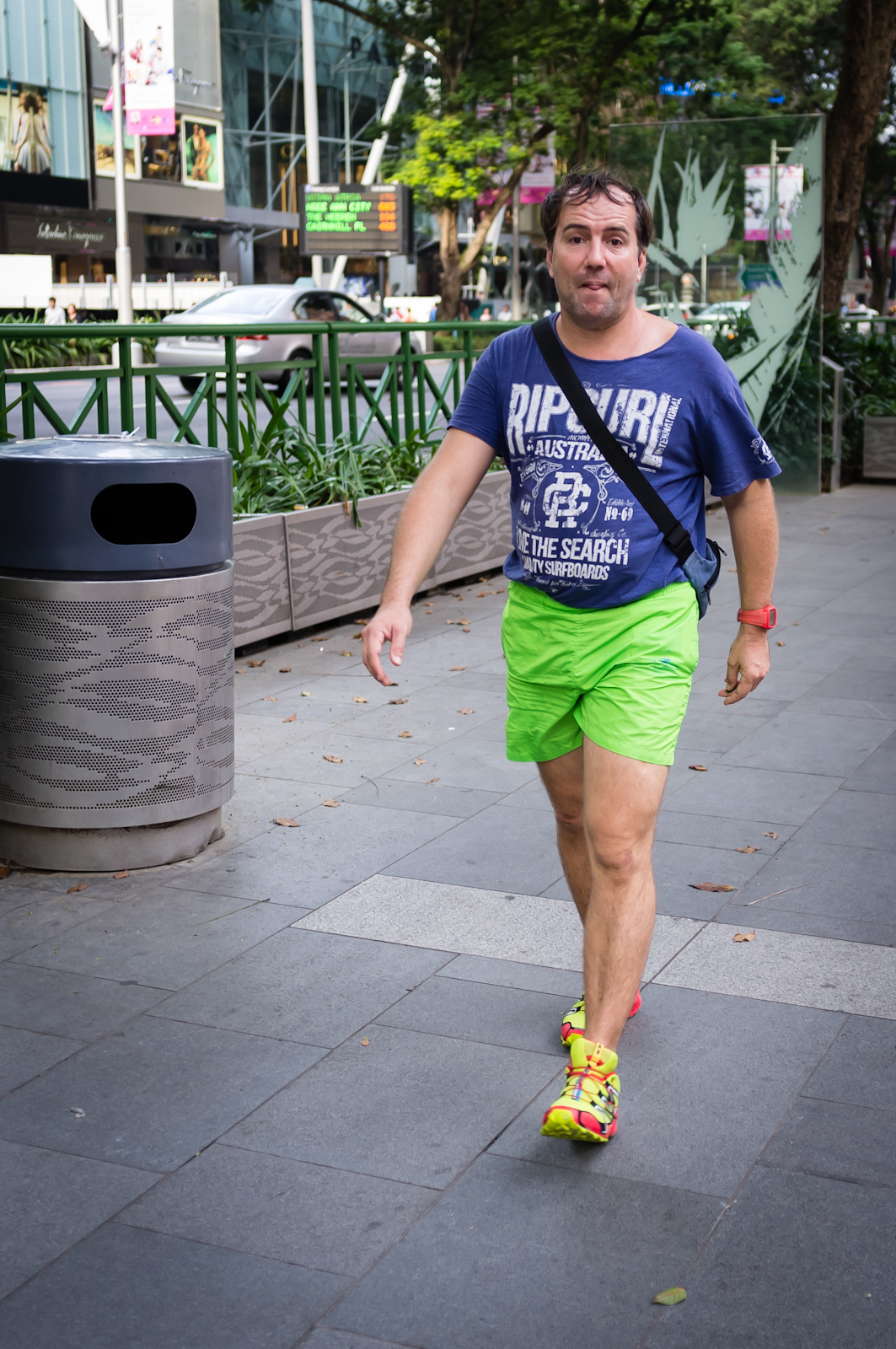 Street photography - Tourist in blue top, green shorts and yellow shoes