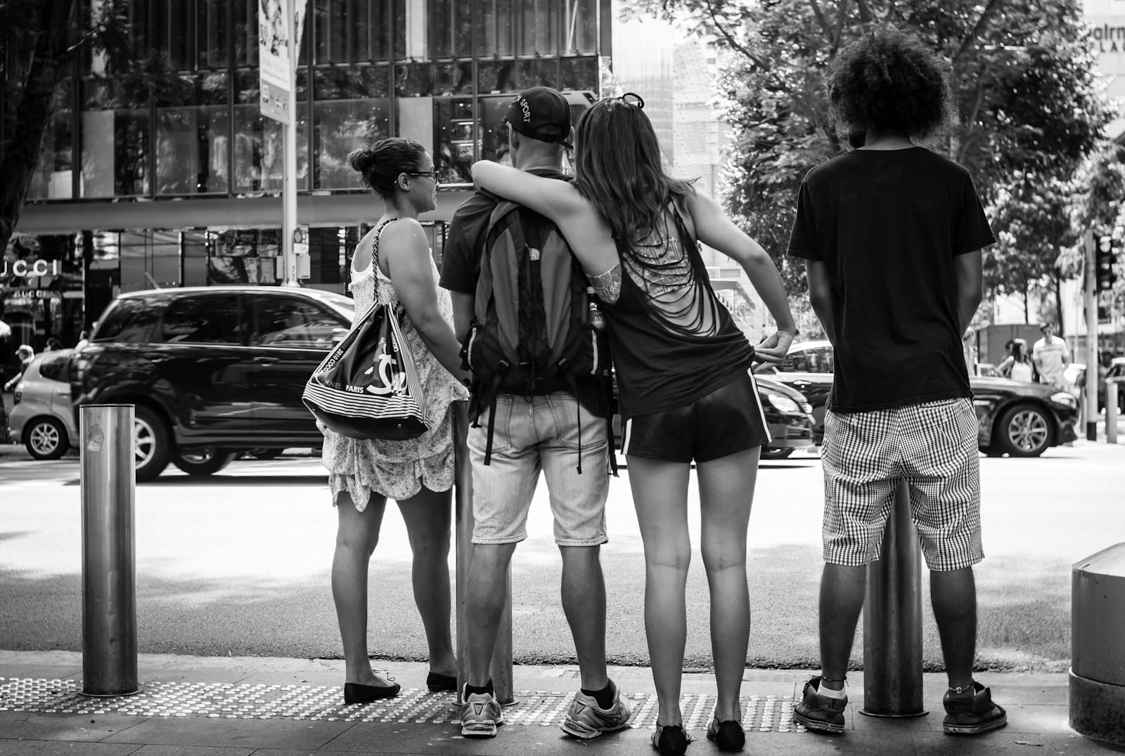 Street photography - four friends waiting to cross the road