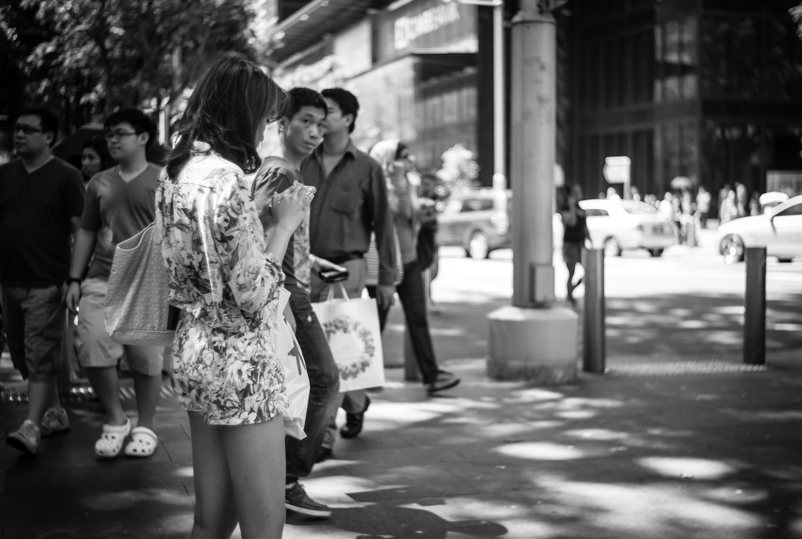 Street photography - girl in floral clothing standing in the middle of the side walk