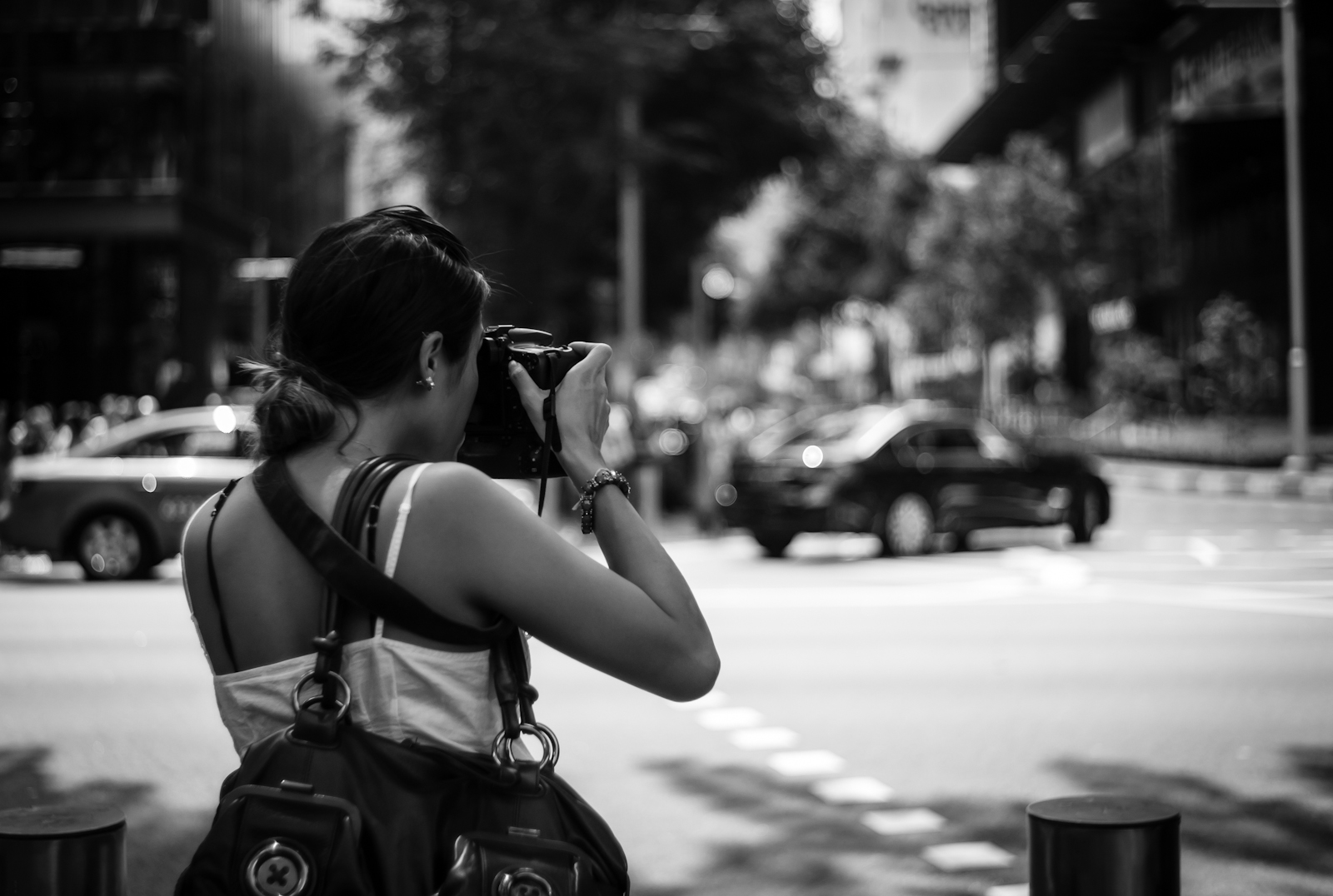 Street photography - Woman shooting with a DSLR camera