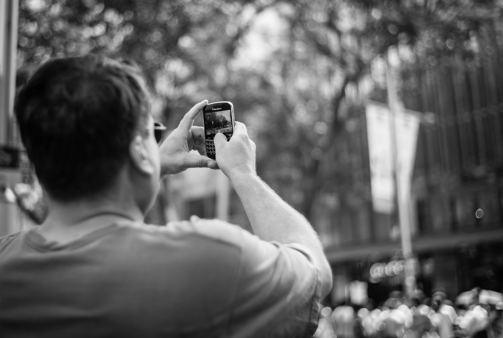 Street photography - Man shooting with his mobile phone