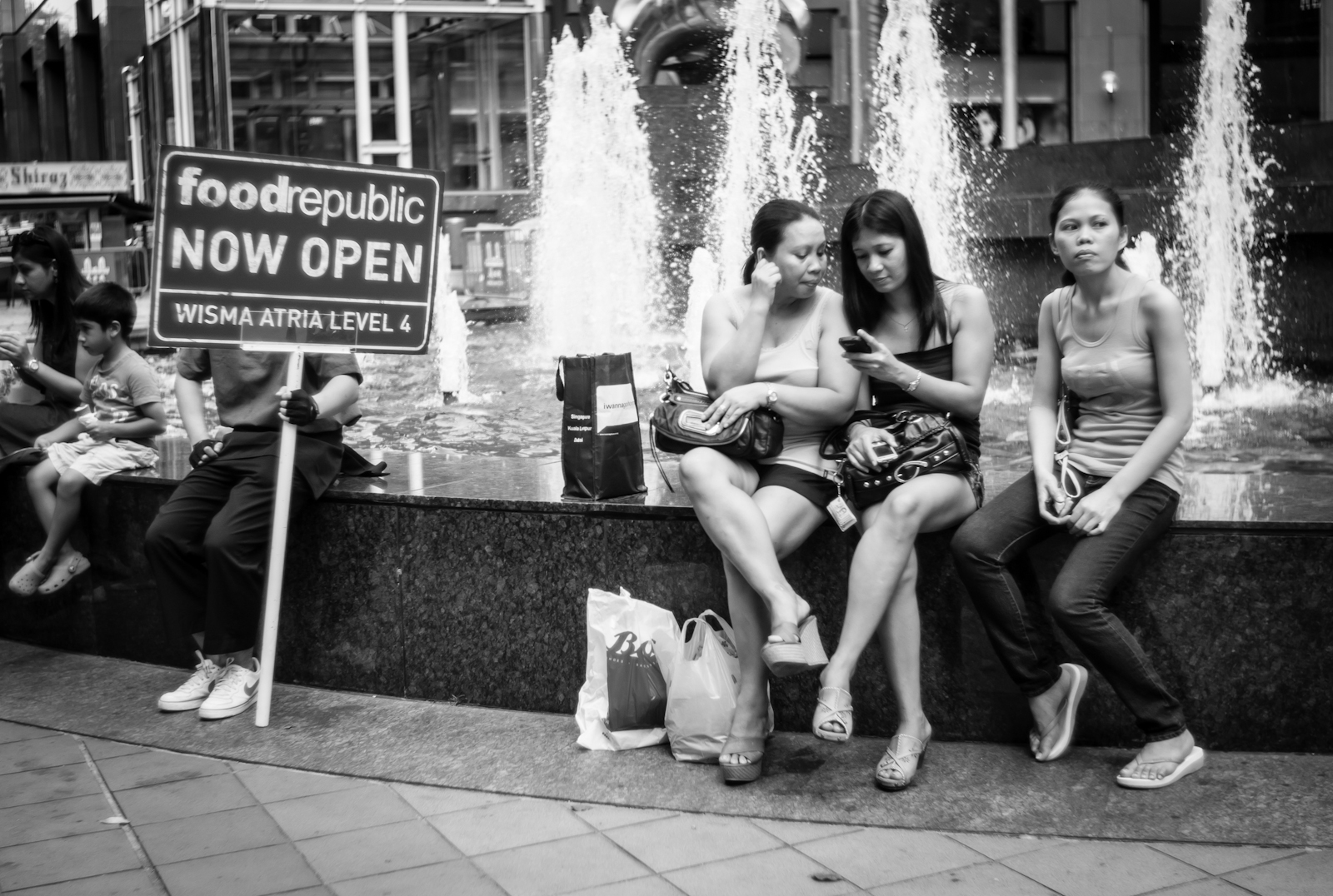 Street photography - People resting at the Ngee Ann City fountain