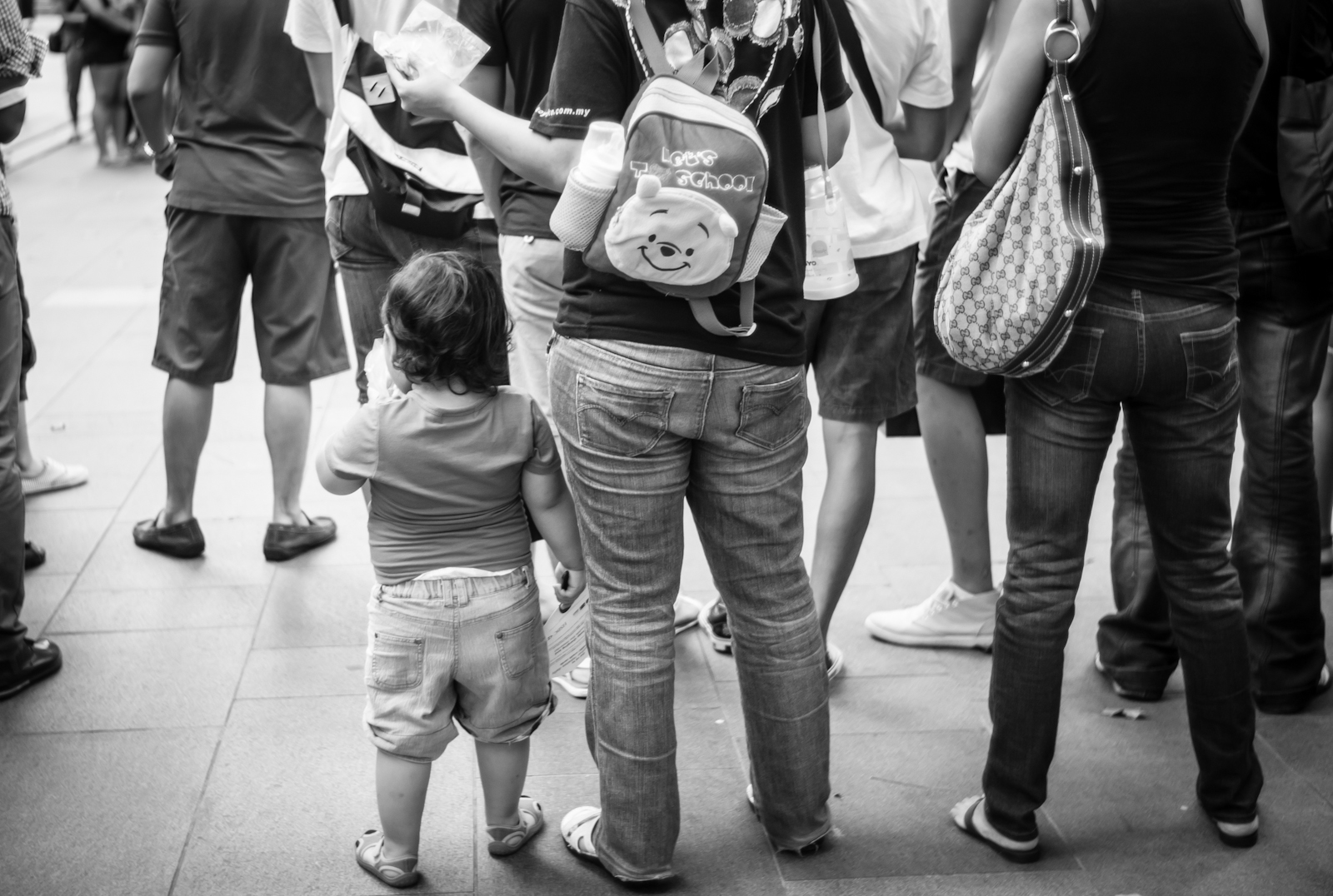 Street photography - Mother carrying Winnie the Pooh bag