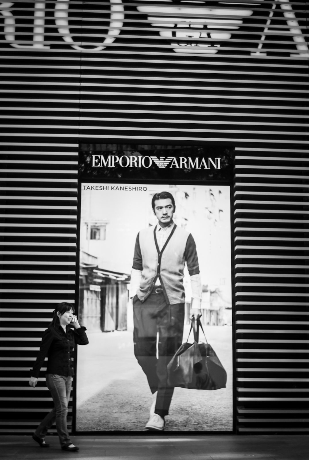 Street photography - Woman walking in front of Emporio Armani