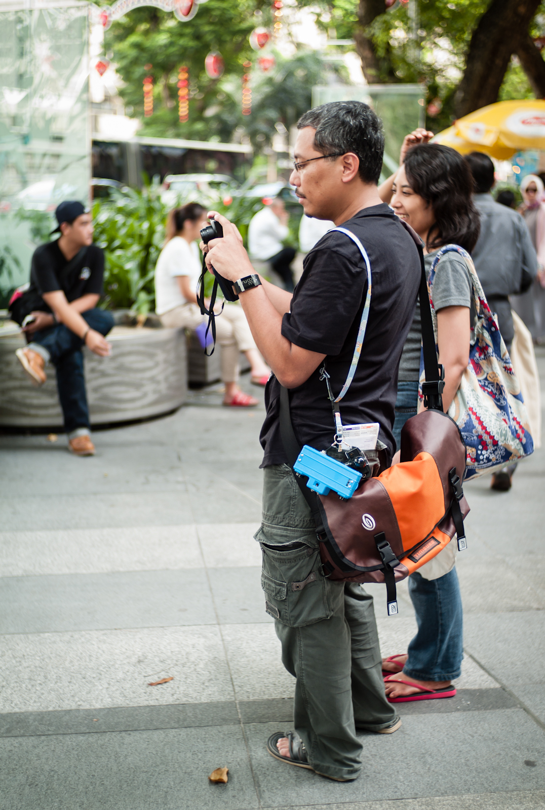 A man with cameras dangling from his bag