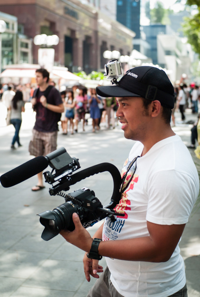 A cameraman wearing a cap
