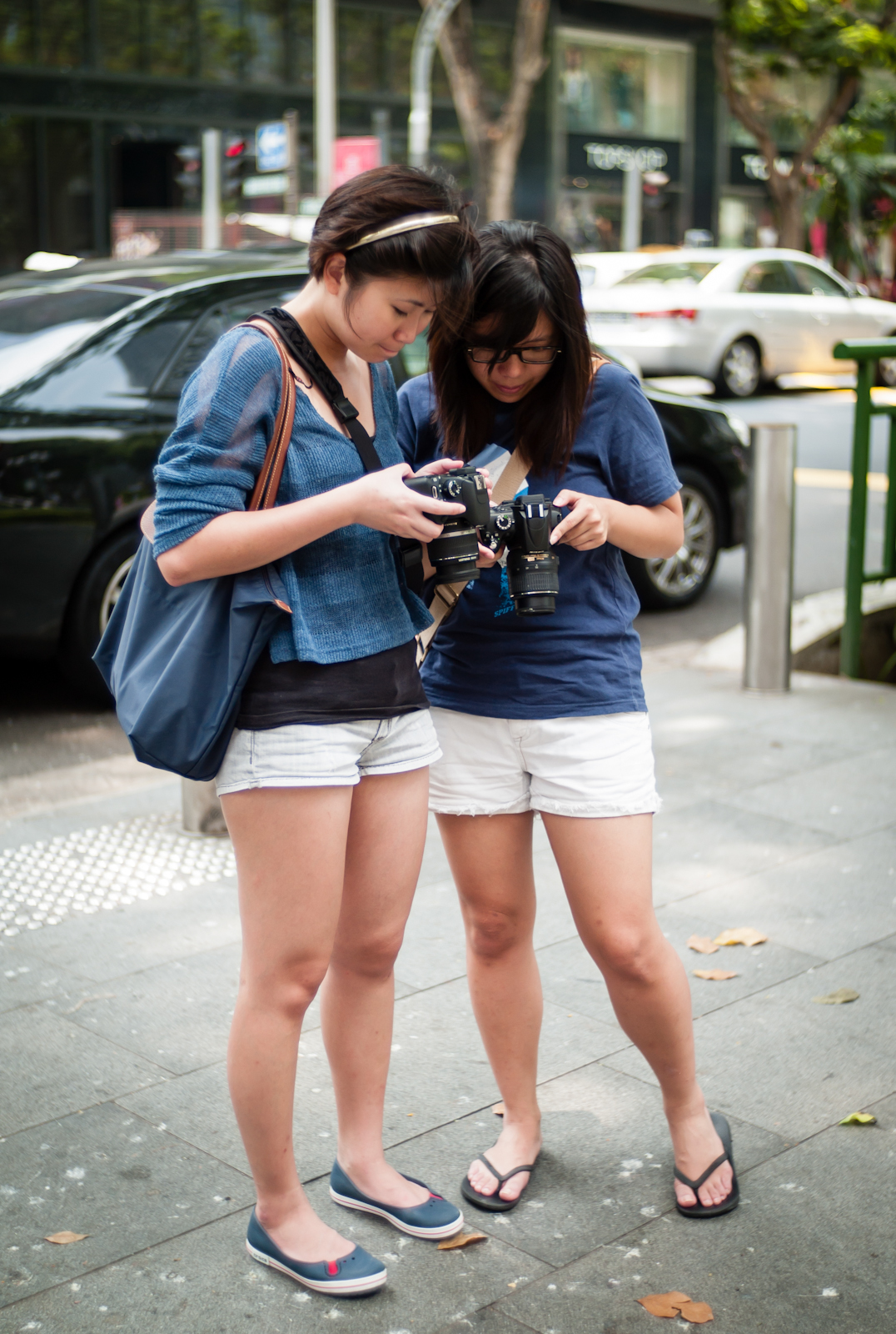 Two photographers checking their images on their camera screens