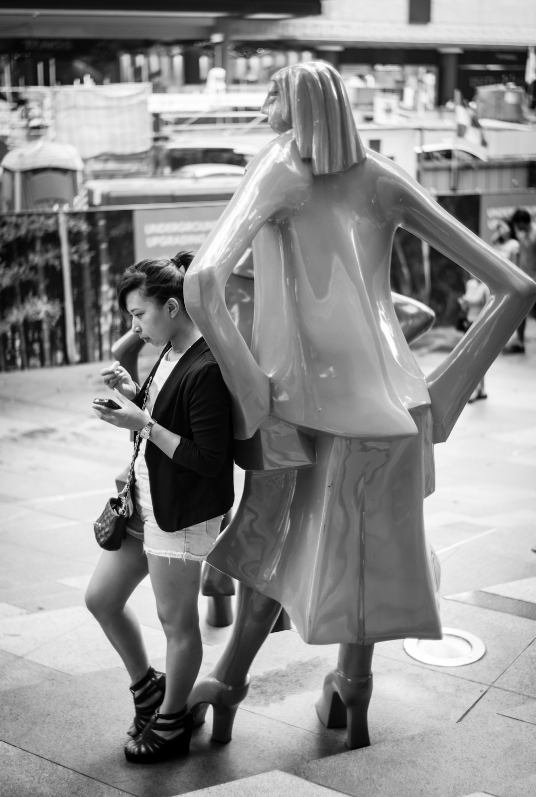 Tourist with a statue in Orchard Road
