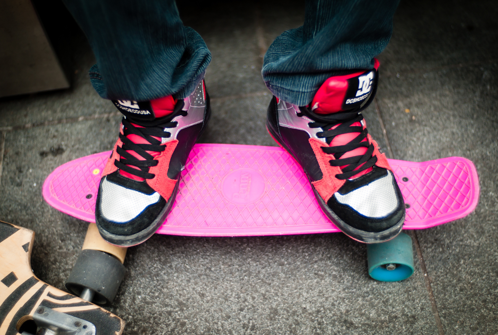 A boy's sneakers and skateboard
